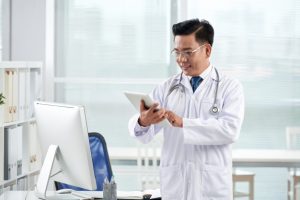 asian-doctor-using-medical-app-his-digital-device_